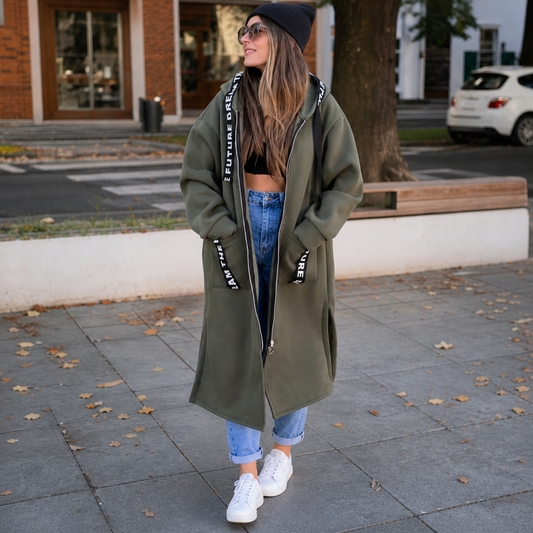 Olive green hooded longline coat with zipper front, pockets, and printed lettering trim