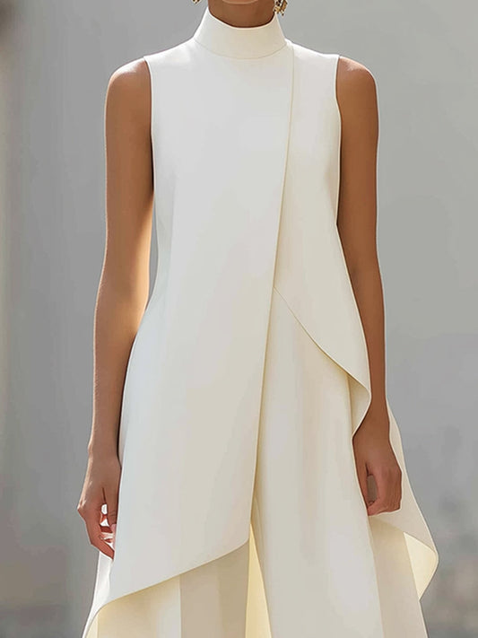 White sleeveless asymmetric top with draped panels and wide-leg pants