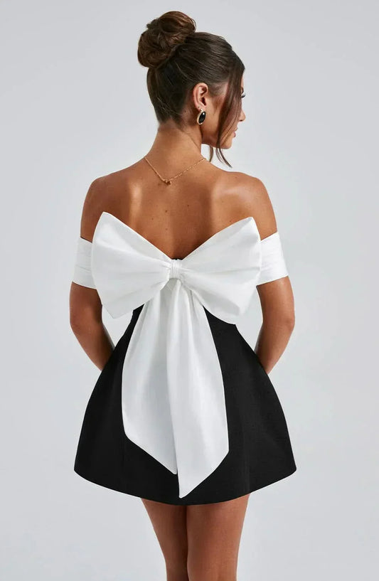 Black off-shoulder mini dress with large back bow and short flared skirt
