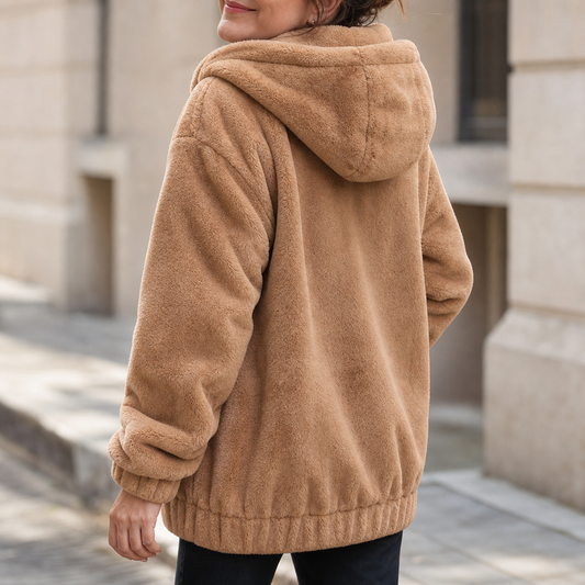 Plush-lined hooded vest with drawstring hood and front pockets, tan/beige color.