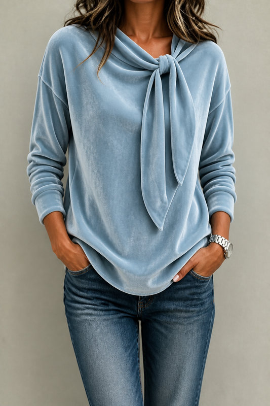 Light blue velvet tie-neck blouse with long sleeves and a curved hem