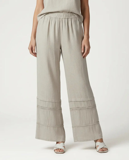 Beige wide leg trousers with lace-trimmed lower panels and elastic waist