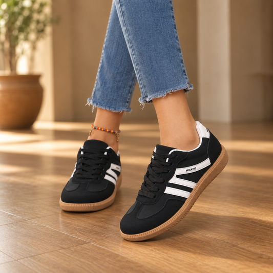 Black cushioned wide-toe sneakers with white stripes and lace-up tan sole