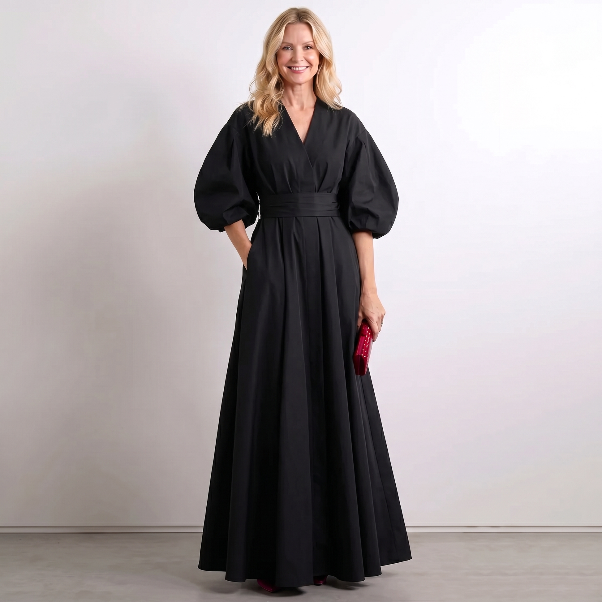 Black A-line maxi dress with short puff sleeves, V neckline, and belted waist