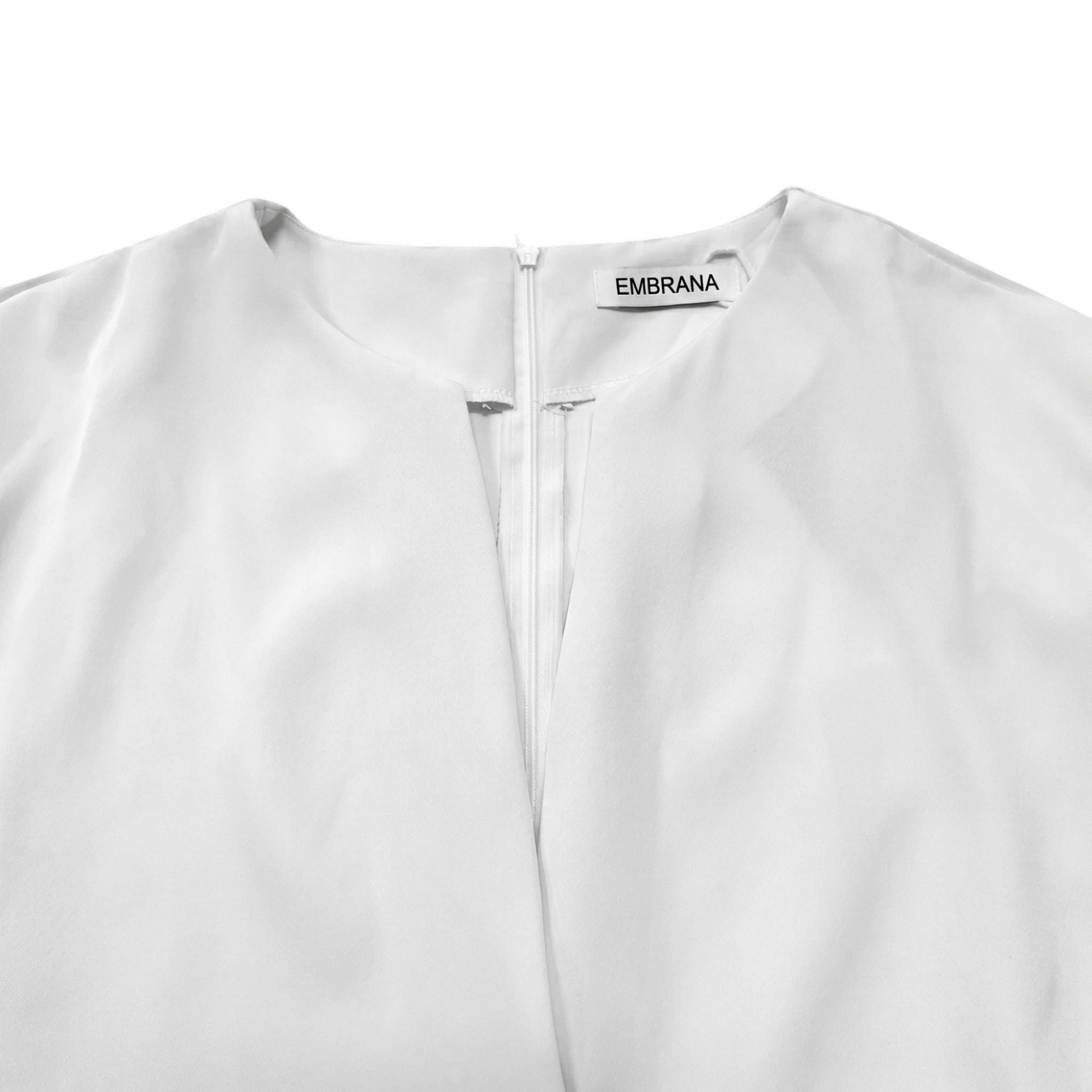 White dress neckline with zipper placket and EMBRANA label
