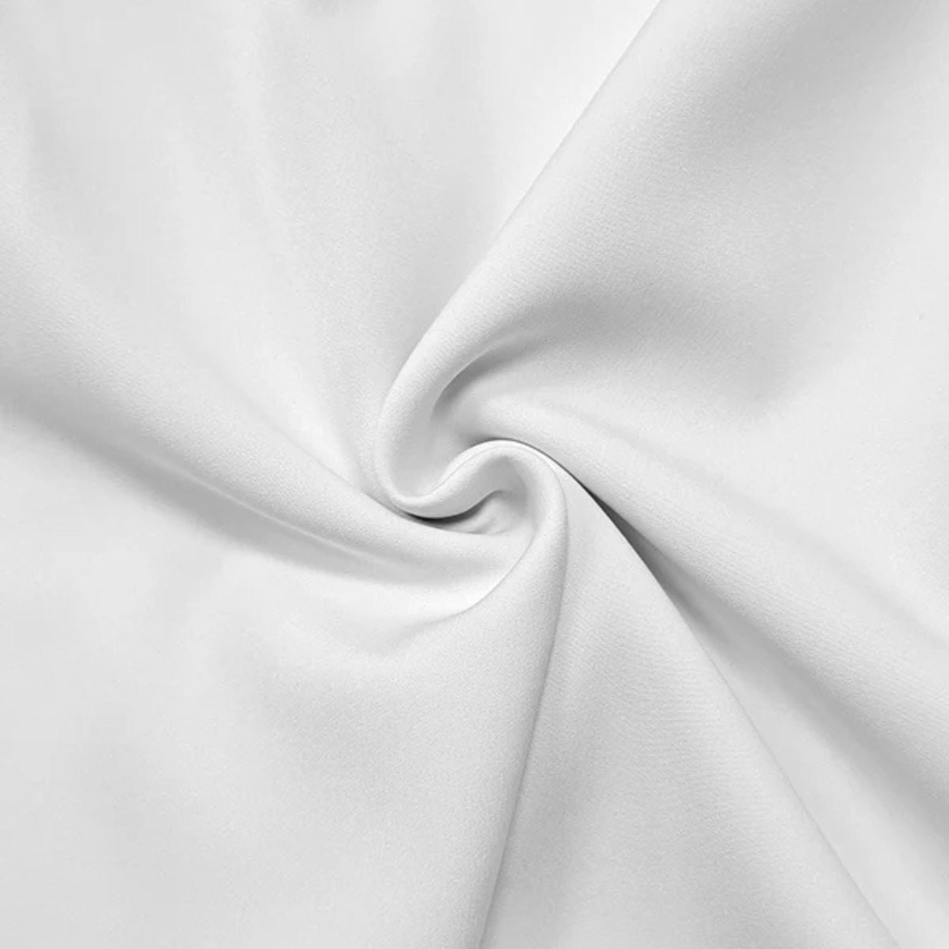 White fabric close-up with soft drape and smooth woven texture