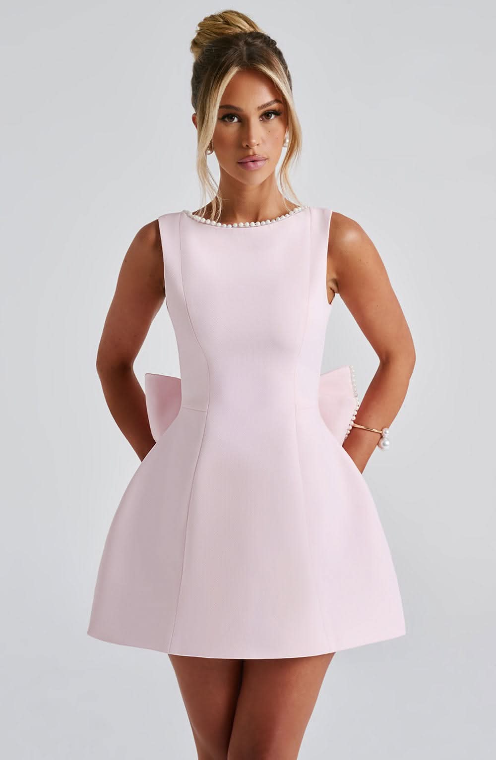 Pink A-line mini dress with sleeveless bodice and pearl-trim round neckline