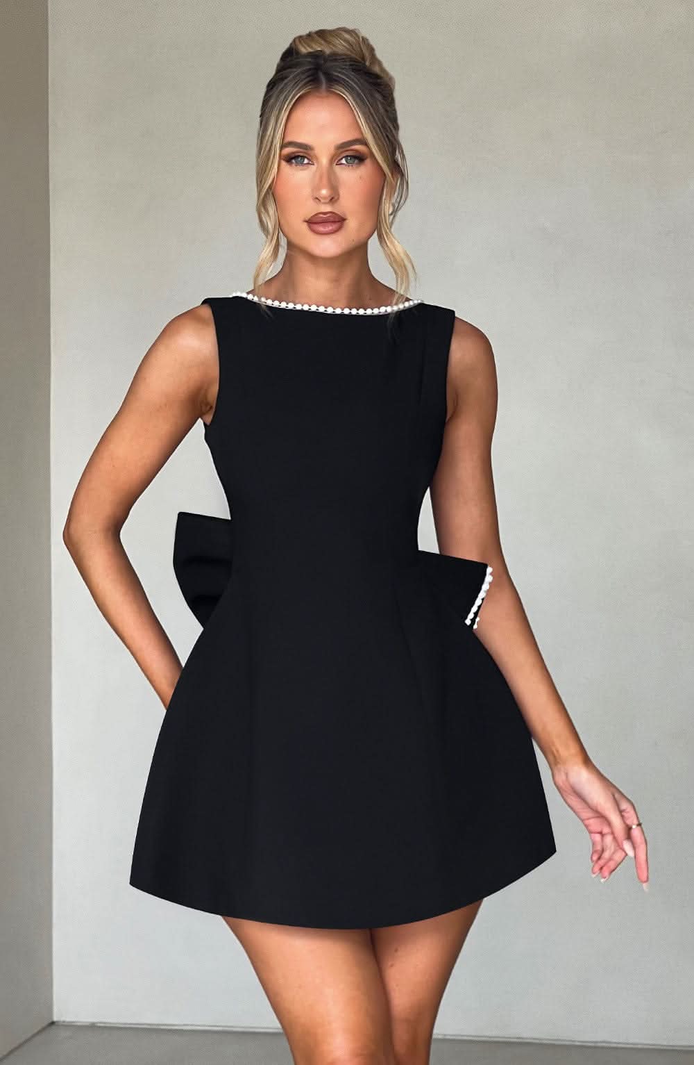 Black A-line mini dress with sleeveless design and pearl-trim round neckline