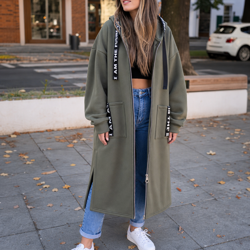 Olive green hooded longline coat with front zipper, side pockets, printed lettering trim