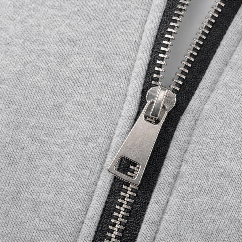 Close-up of silver zipper and black zipper tape on the gray hooded jacket