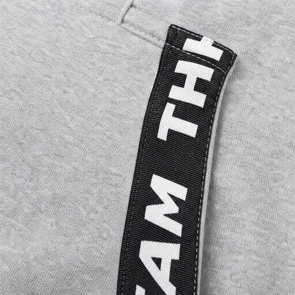 Light gray zip-up hooded jacket with black letter tape patch on sleeve