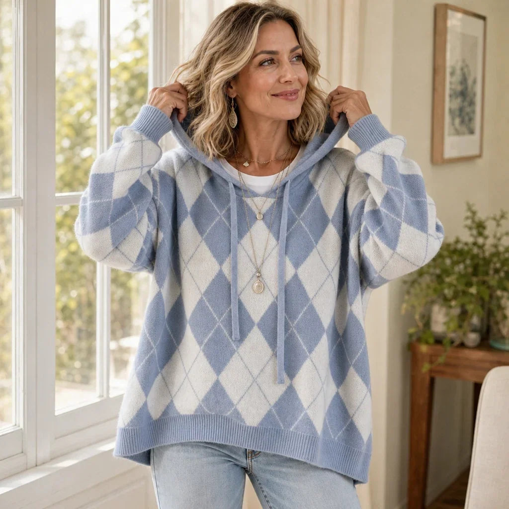 Blue and cream argyle sweater with a hood, drawstrings, and roomy sleeves.