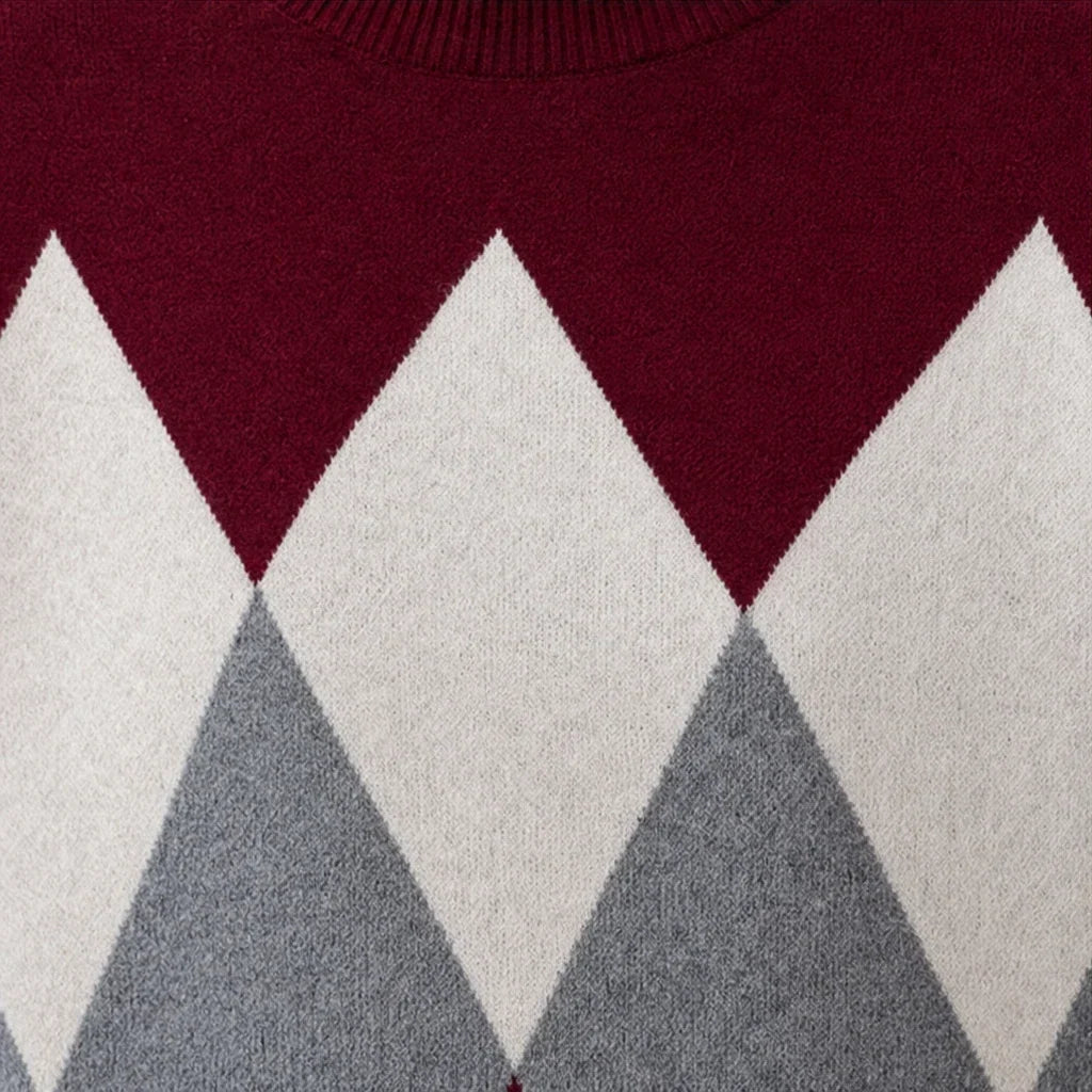 Close-up of the sweater's white and gray argyle knit pattern