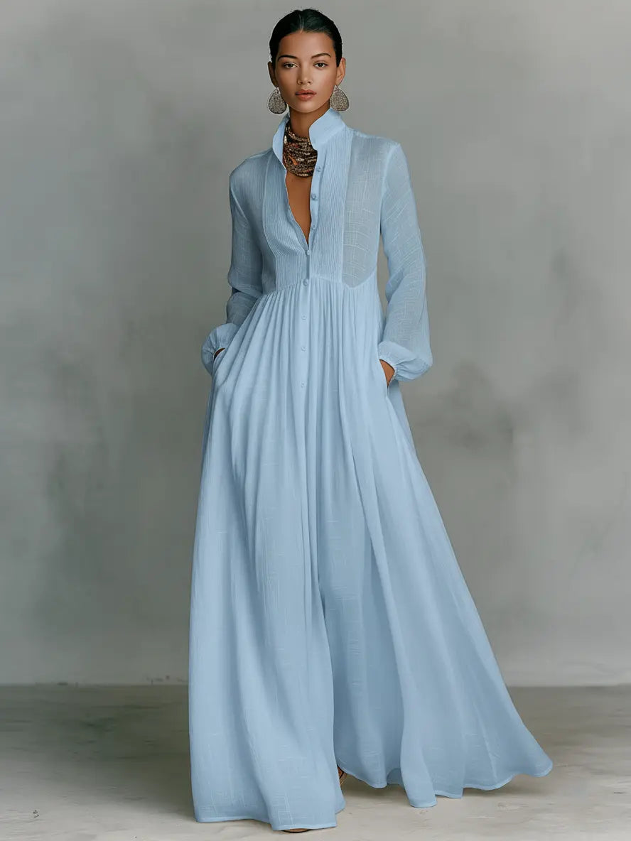 Light blue maxi dress with long sleeves, v-neck, and gathered bodice