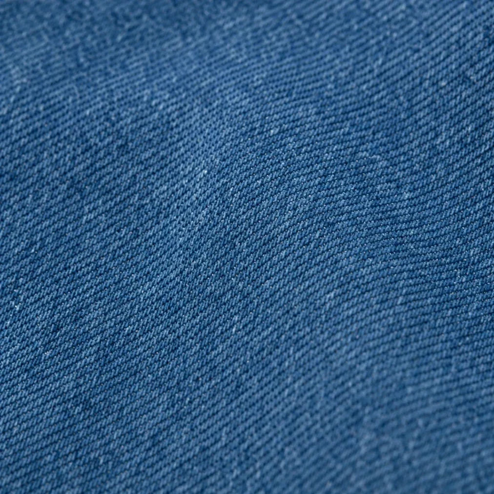 Blue denim-look jacket fabric with a visible diagonal weave