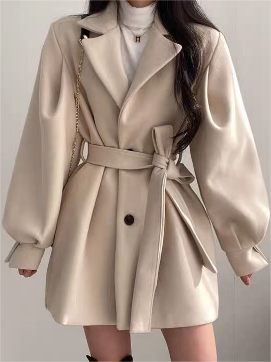 White belted coat dress with button front, side pockets, and puff sleeves