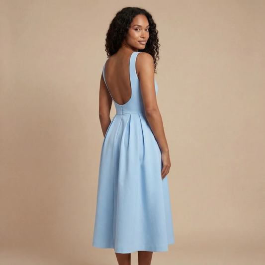 Light blue fit-and-flare midi dress back view with open-back straps and gathered skirt.
