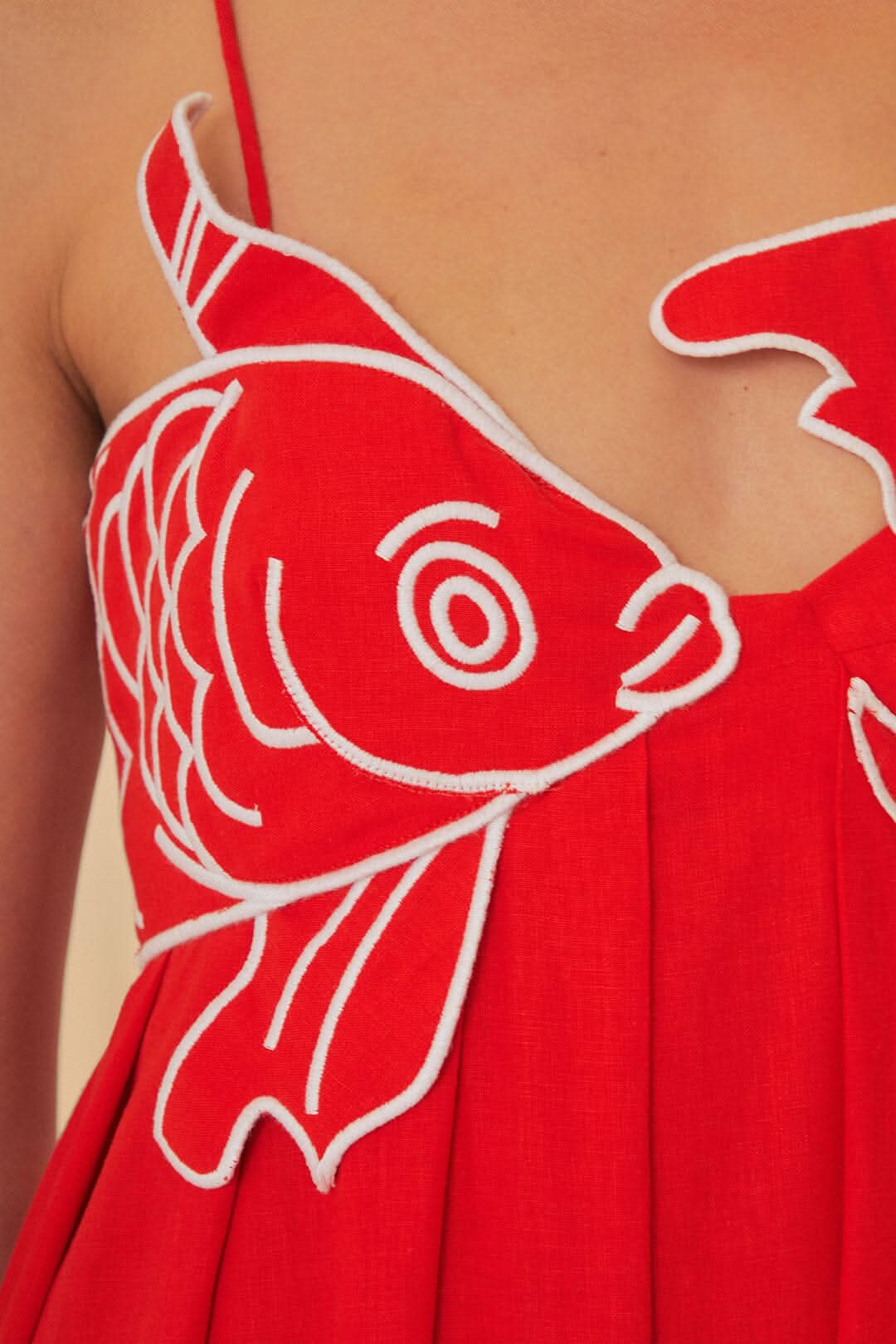 Red spaghetti-strap maxi dress with bold white fish graphic detail