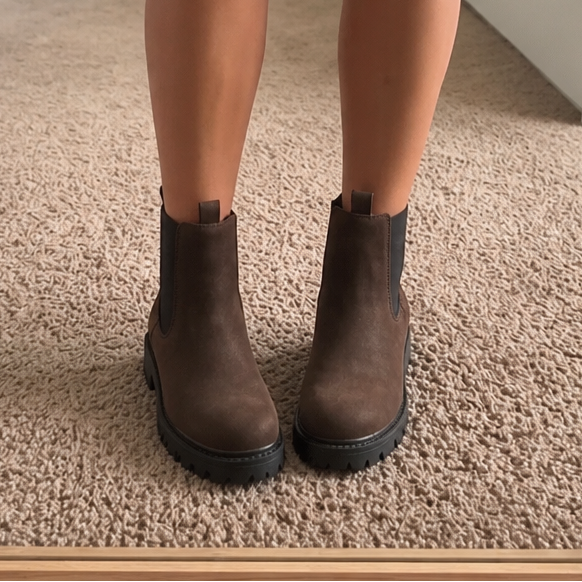 Dark brown Chelsea ankle boots with elastic side panels and black lug sole