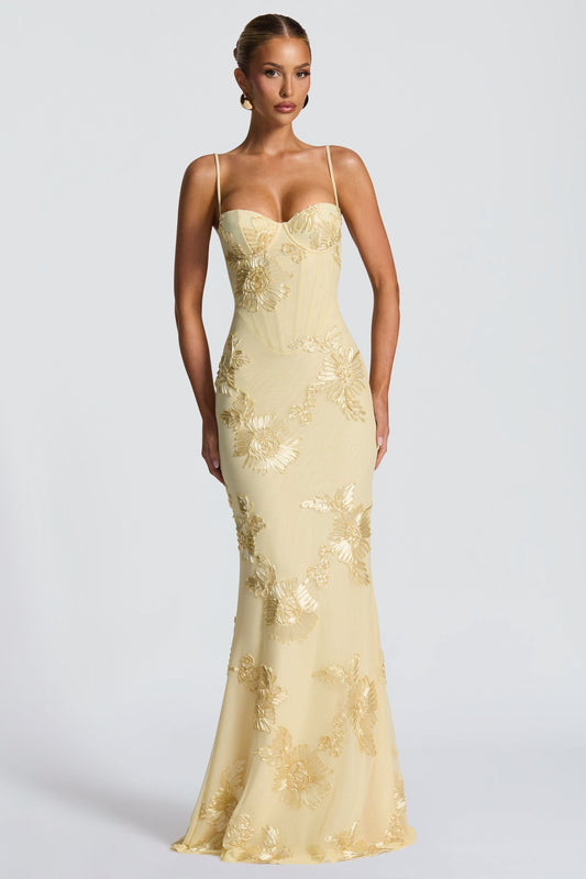 Yellow bustier maxi dress with gold floral applique and thin spaghetti straps