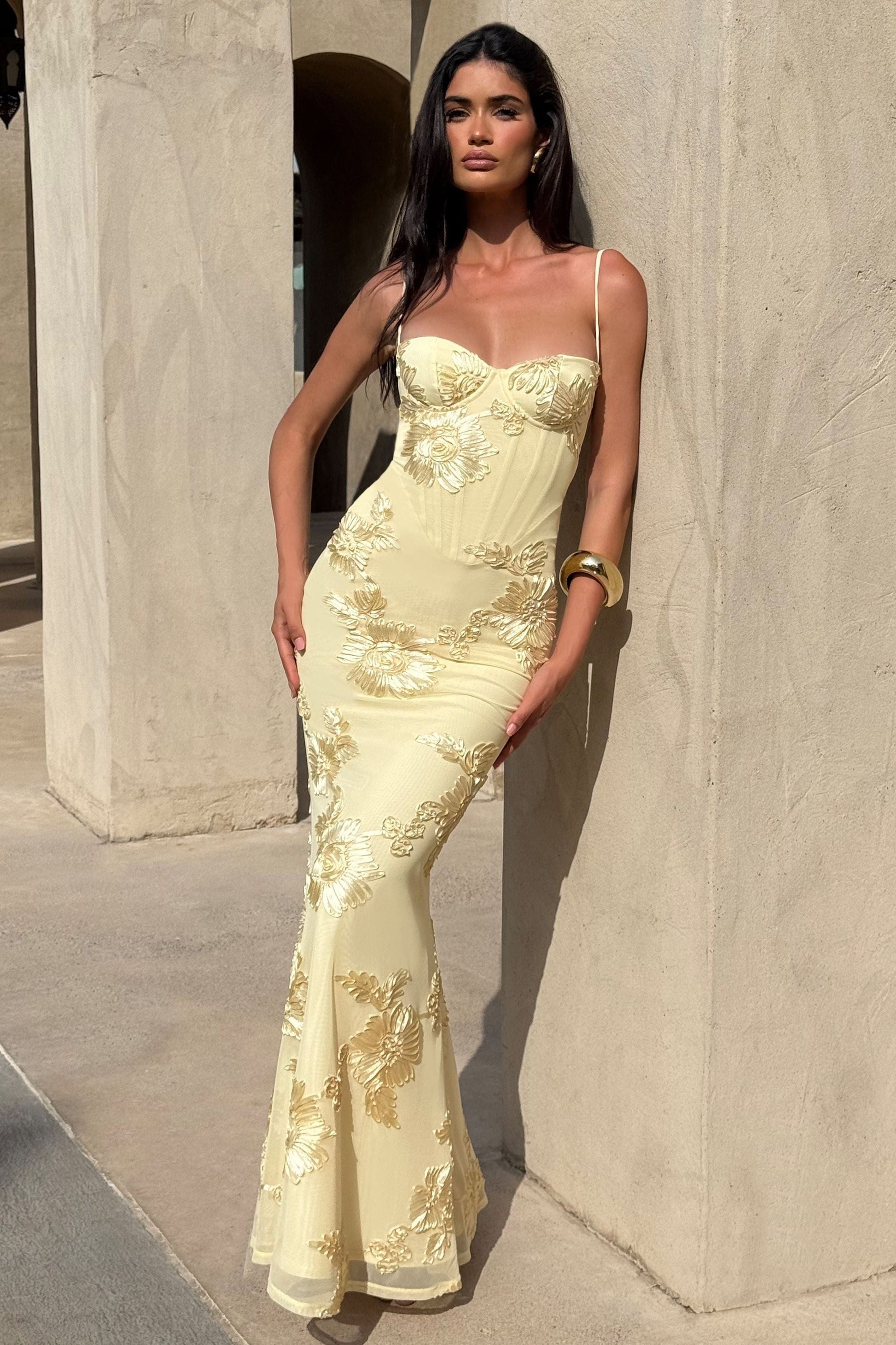 Yellow bustier maxi dress with floral applique and thin straps, fitted maxi length