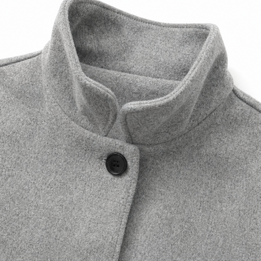 Light grey stand collar with black button, inner facing visible