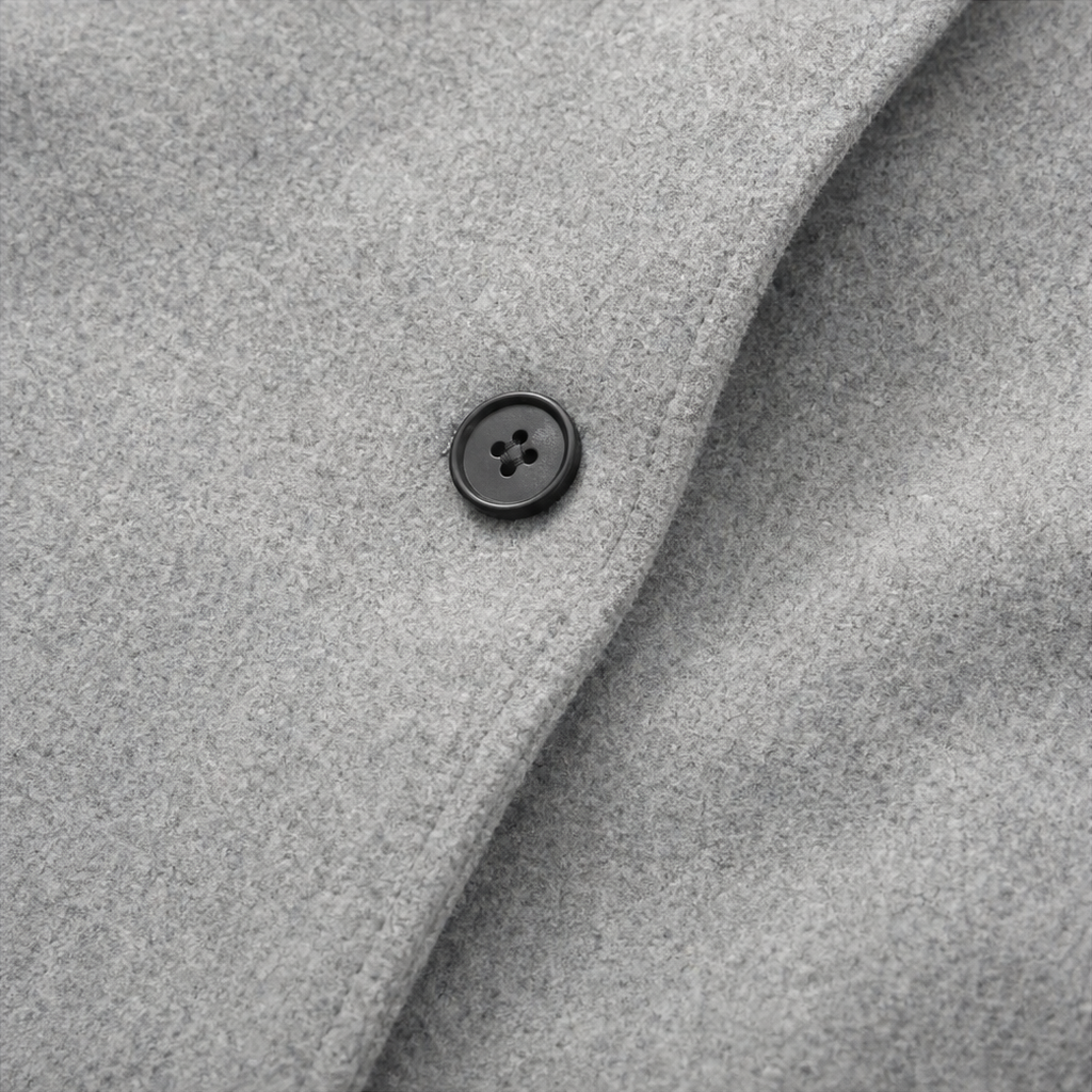 Light grey coat button detail on button-front placket