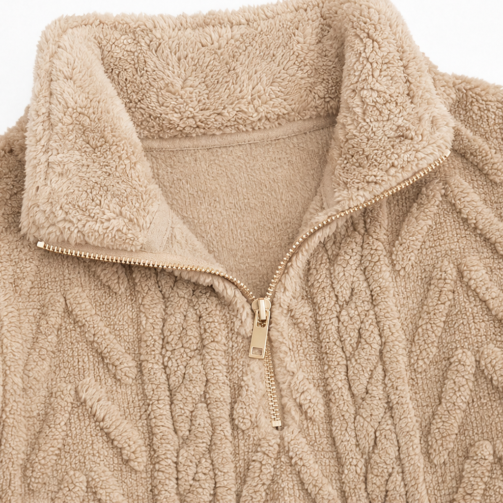 Close-up of tan quarter-zip placket with metal zipper and plush cable-knit texture