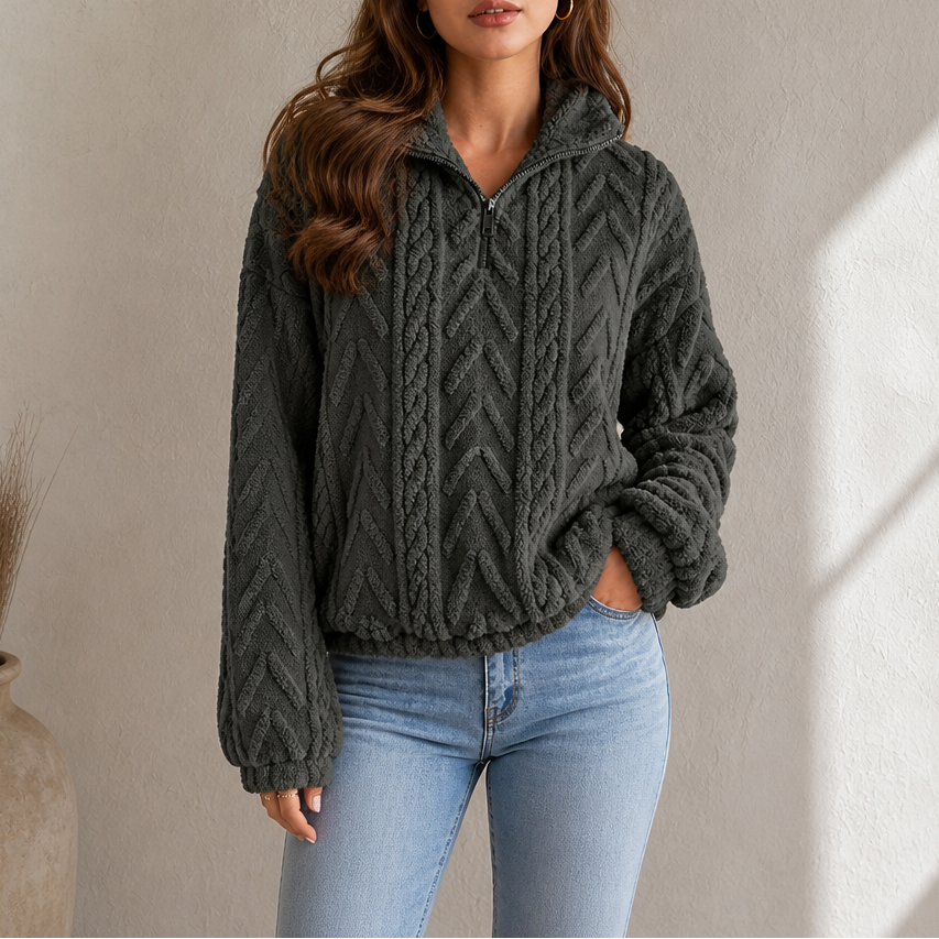 Dark gray cable-knit quarter-zip pullover with chunky cable texture and zip neck