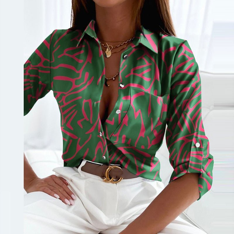 Collared button-up blouse in green with pink abstract line pattern, short sleeves