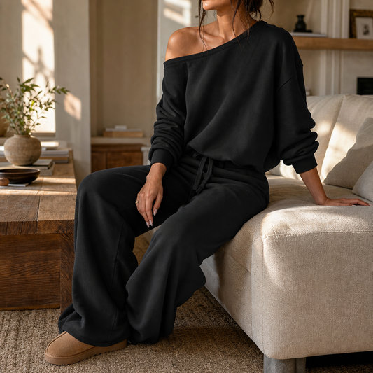 Black off-shoulder loungewear set with relaxed wide-leg pants and drawstring tie waist.