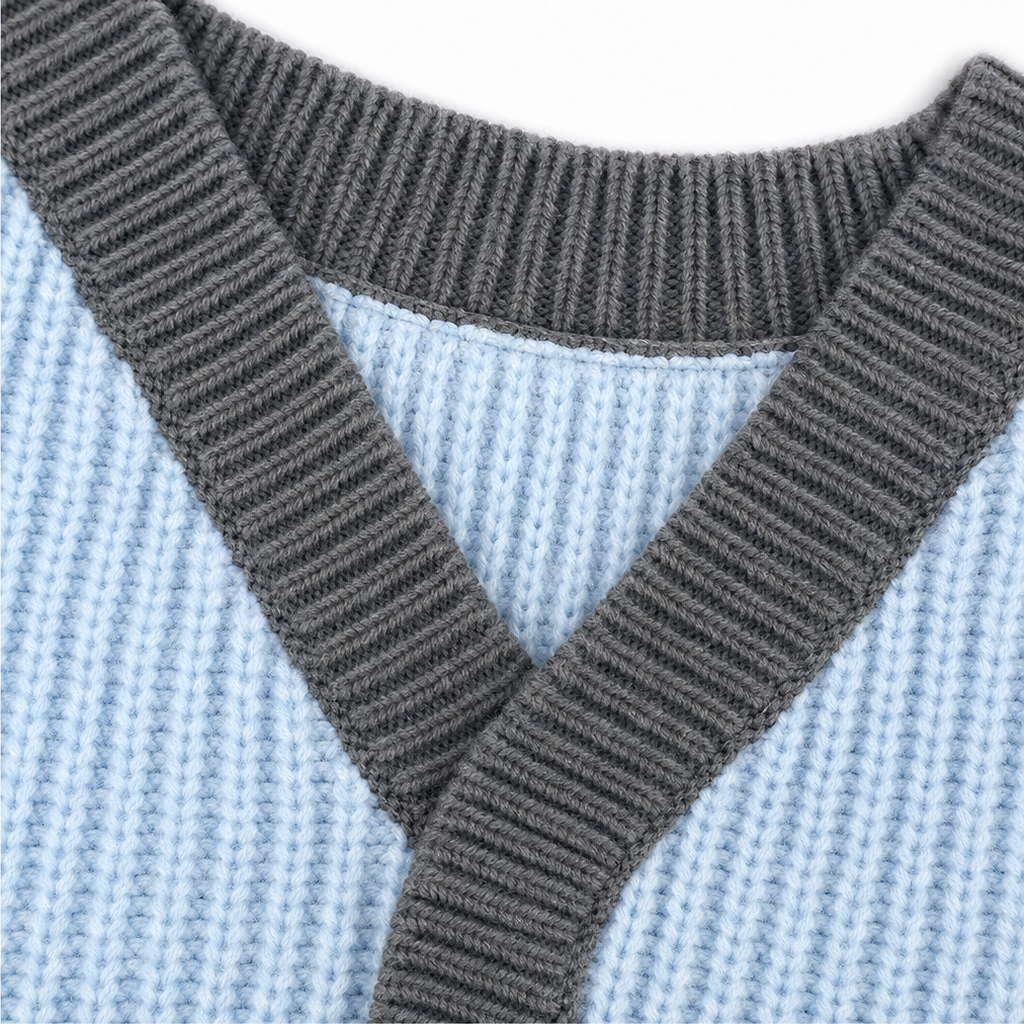 Dark gray V-neck trim over light blue knit sweater