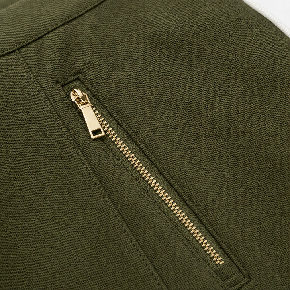 Olive green jacket zipper with gold-tone teeth close-up