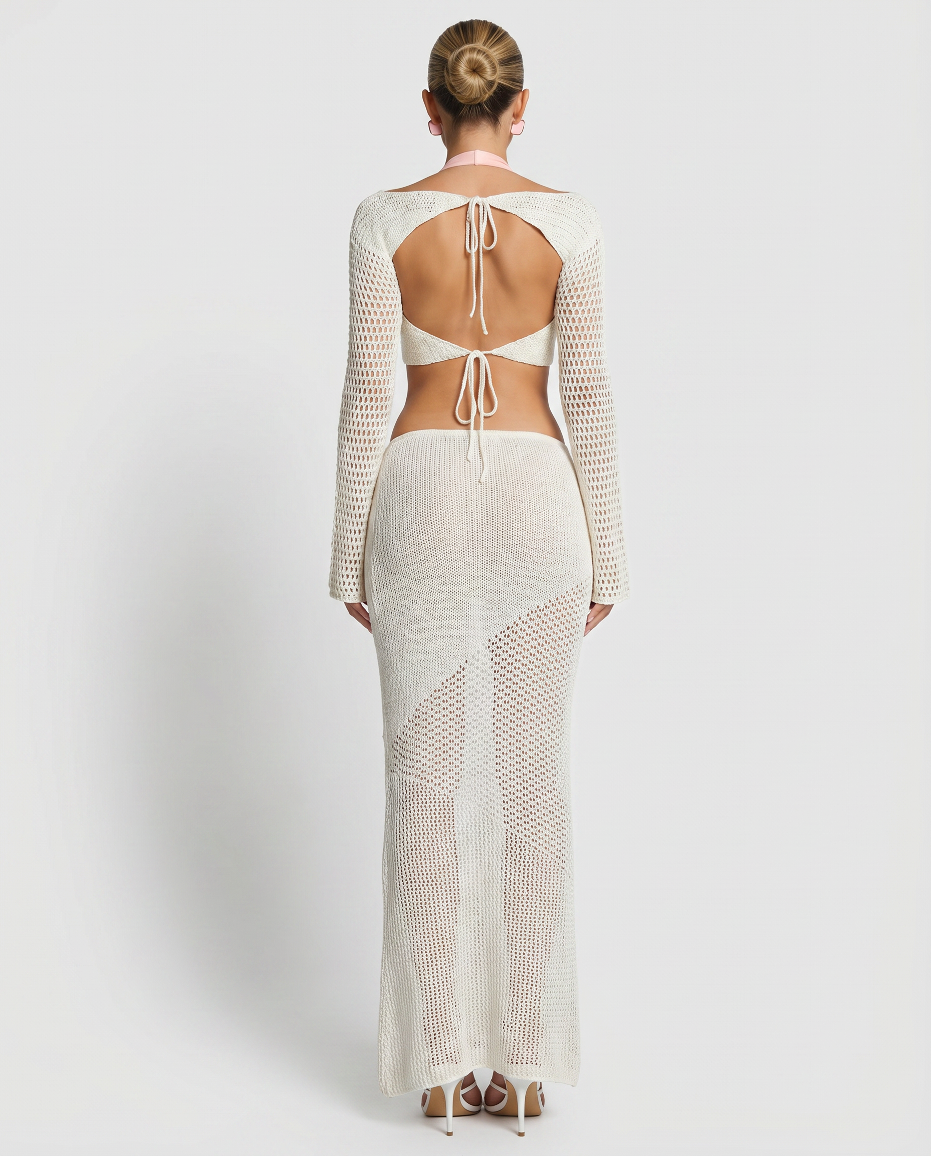 White crochet knit two-piece set, back-tie square crop top and long-sleeve maxi skirt.