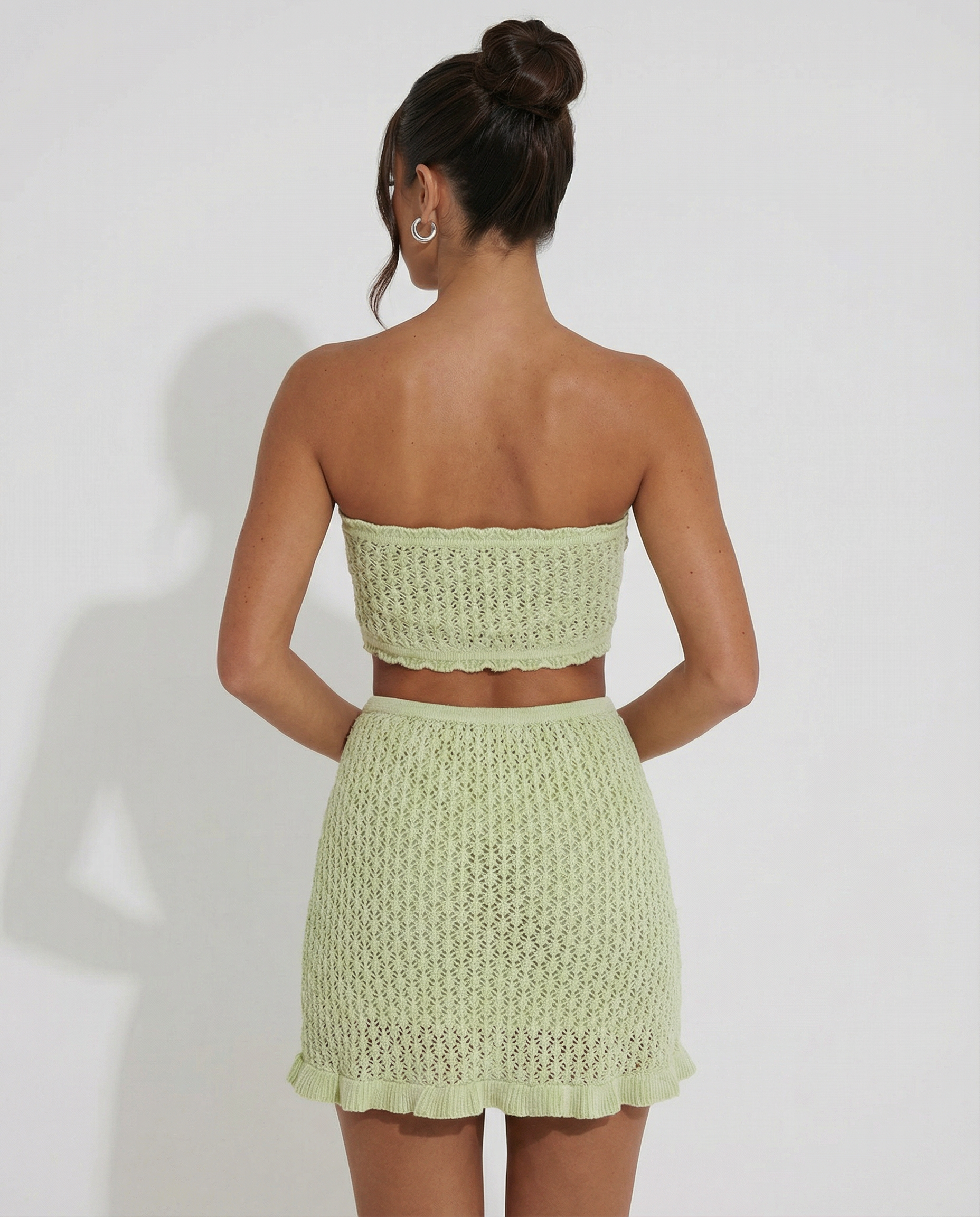 Mint green crochet strapless bandeau and matching ruffled mini skirt set, back view