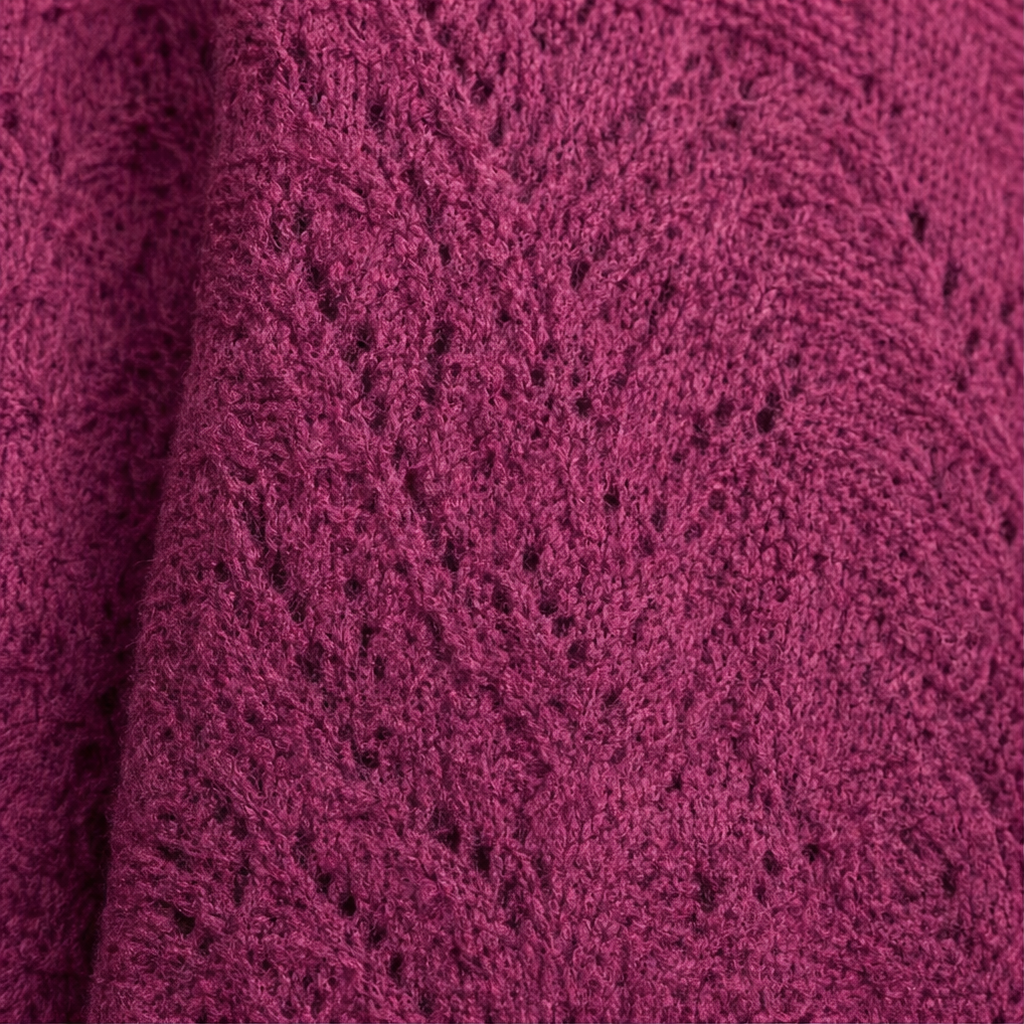 Close-up of purplish-red openwork knit fabric with diamond texture