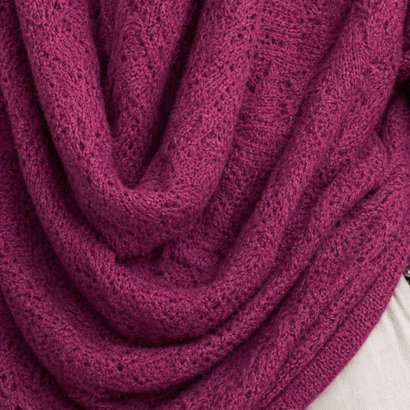 Close-up of purplish-red cowl neckline with textured knit and draped folds