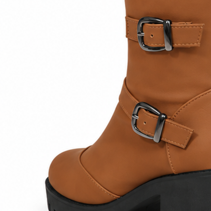 Brown ankle boot with double side buckles and chunky black platform sole.