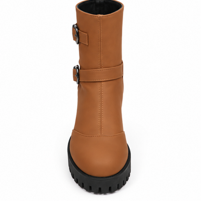 Brown tall ankle boots with double buckles and black lug sole.
