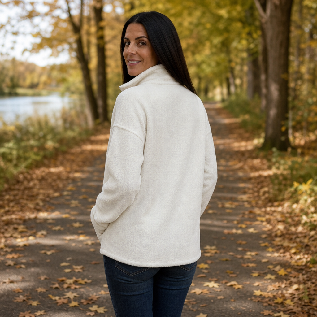 Cream white fleece pullover with quarter-zip and drop-shoulder silhouette