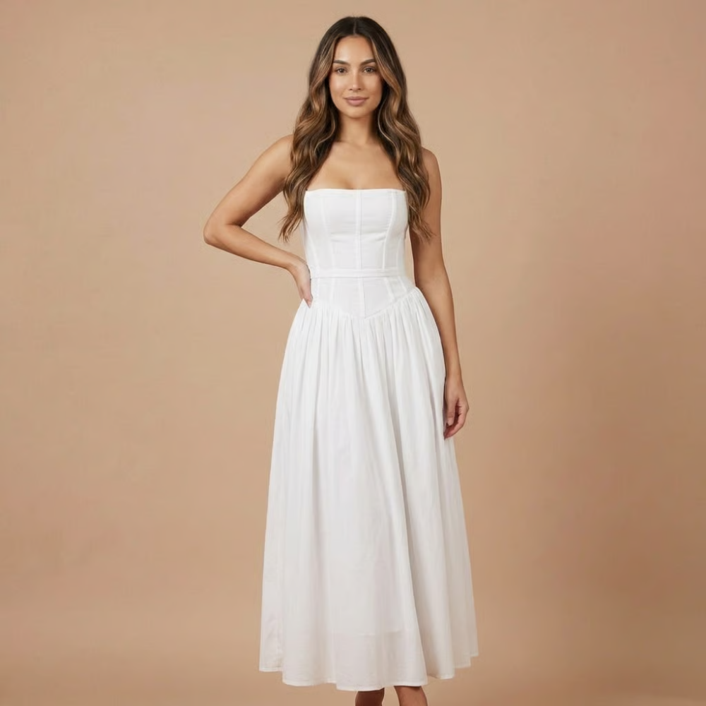 White midi dress with corset-style bodice, spaghetti straps, and gathered skirt