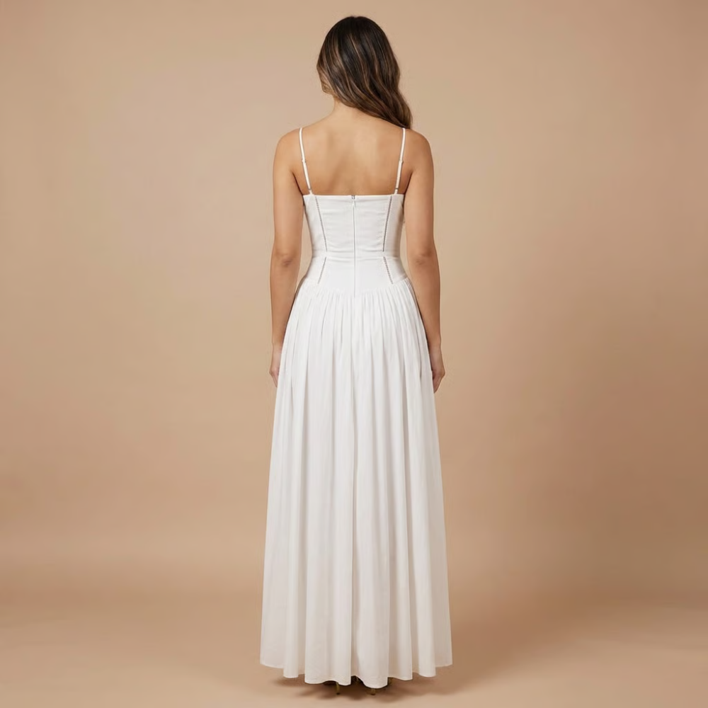 Back view of white midi dress with corset-style bodice and spaghetti straps