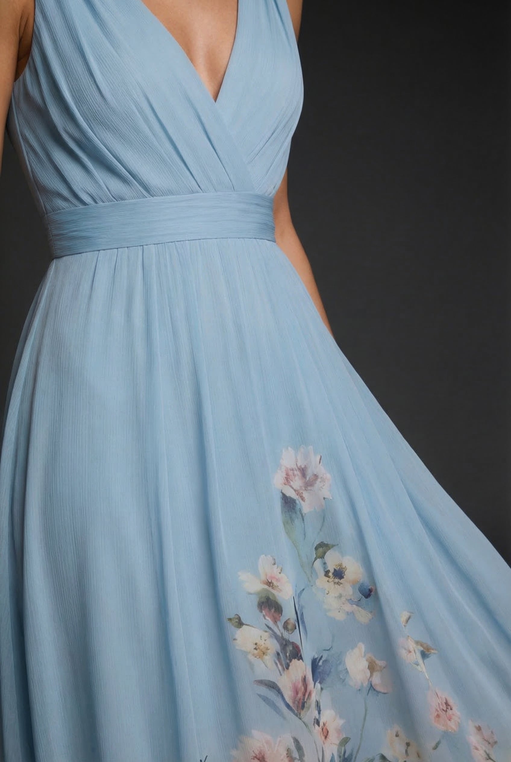 Light blue V-neck maxi dress bodice with cinched waist and floral print on skirt