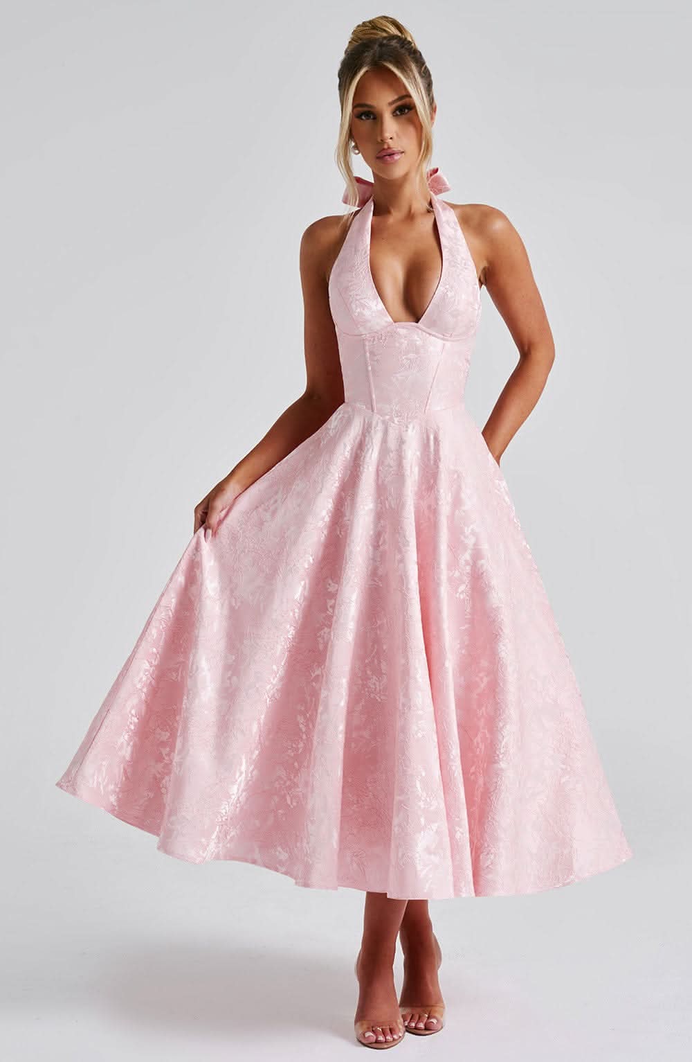 Pink halter midi dress with deep V neckline and floral jacquard flared skirt