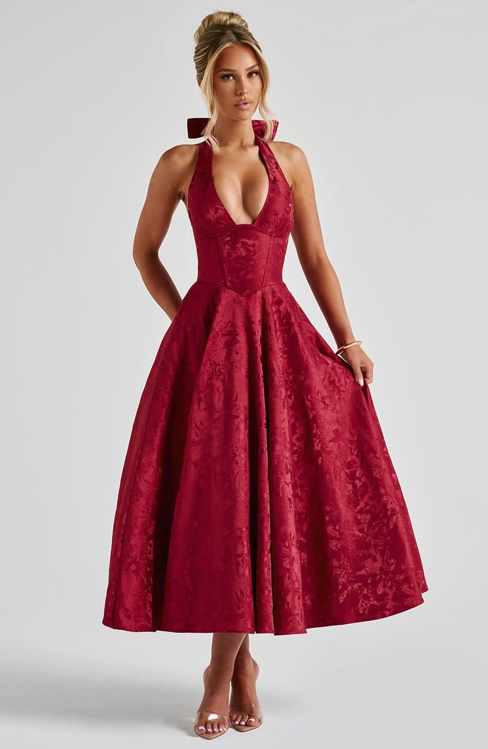 Red halter midi dress with deep V neckline and floral jacquard flared skirt