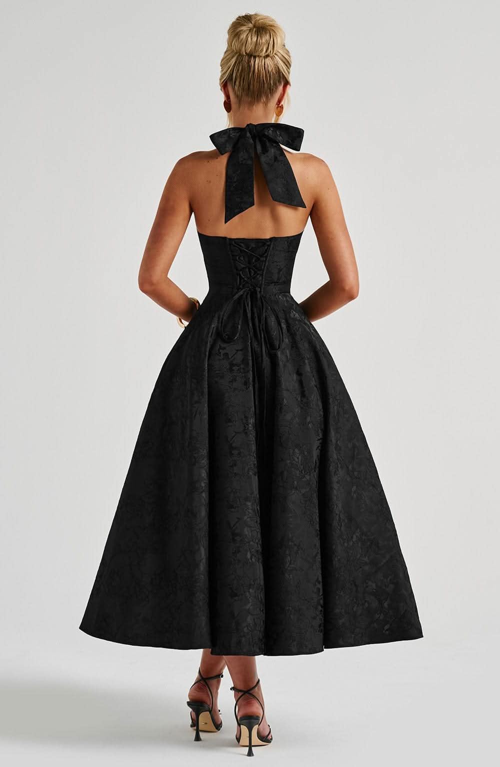 Black halter midi dress back view, open cutout and full gathered skirt