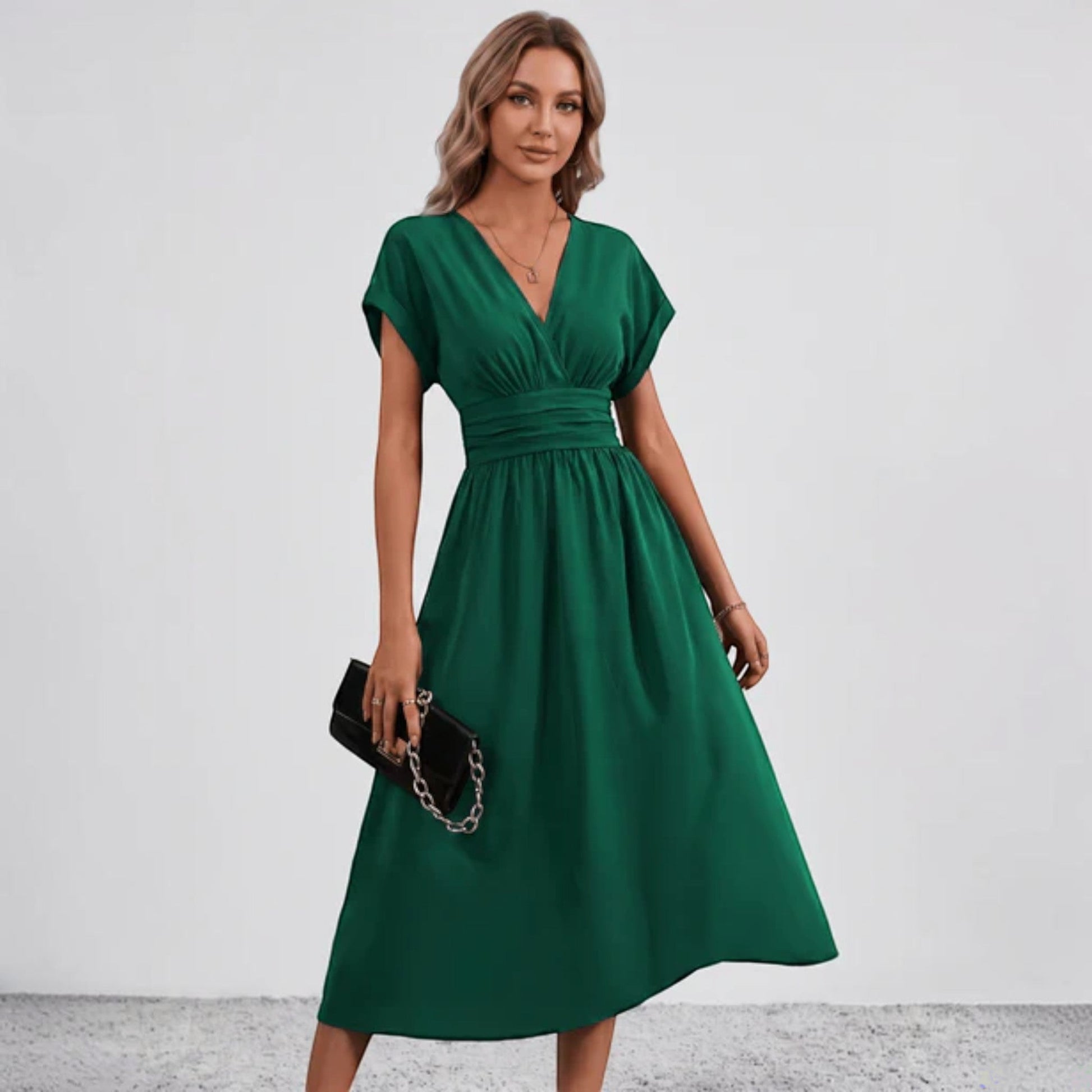 Green V-neck midi dress with ruched waist and short sleeves, flared skirt