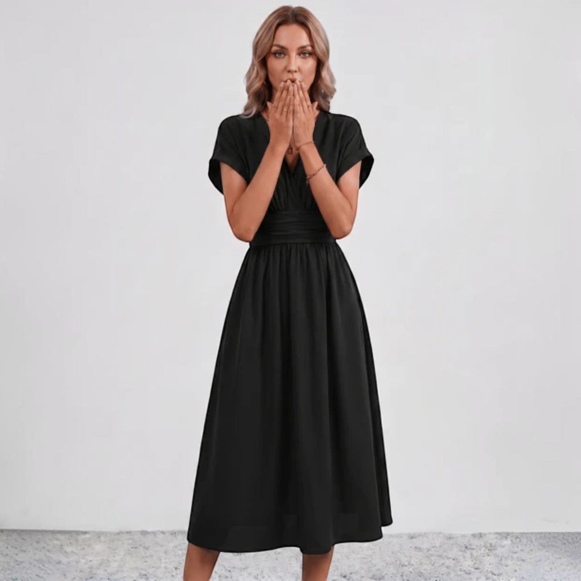 Black midi fit-and-flare dress with V-neck, ruched waist, and short sleeves