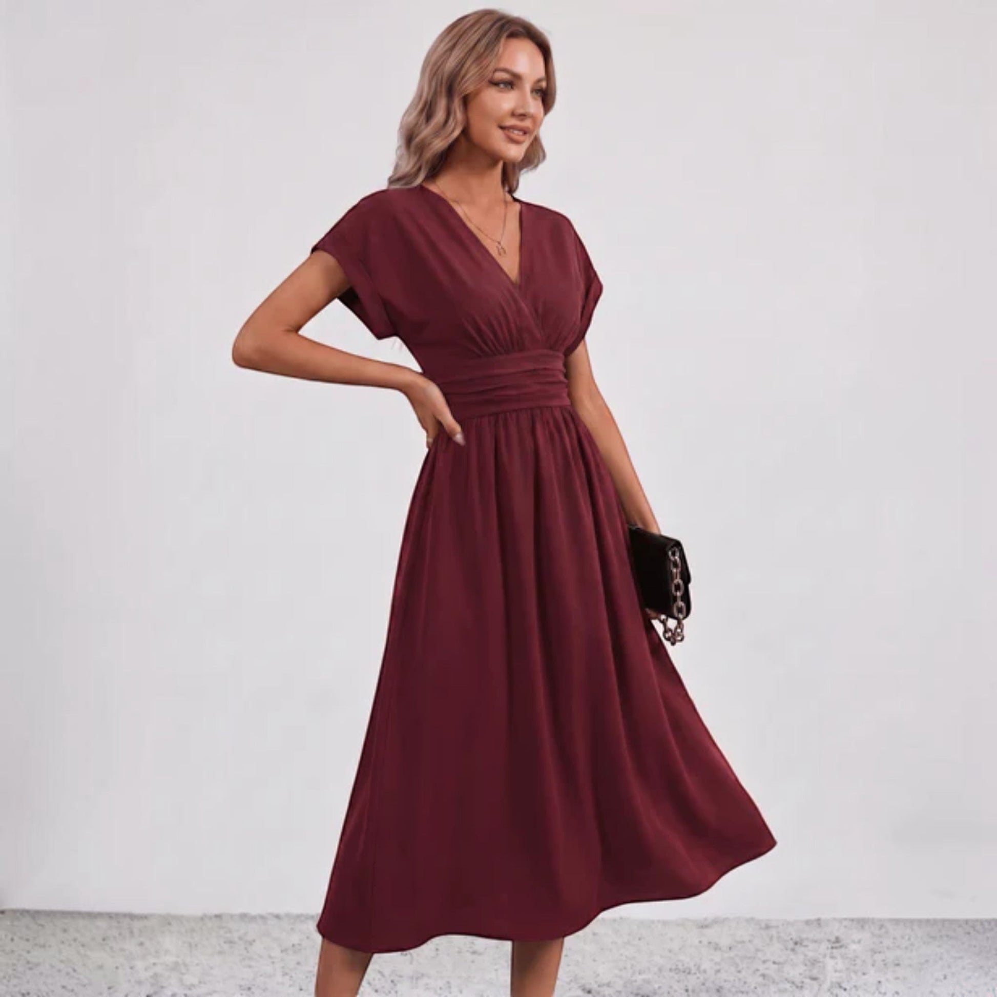Burgundy V-neck midi dress with ruched waist and short sleeves, flowing hem