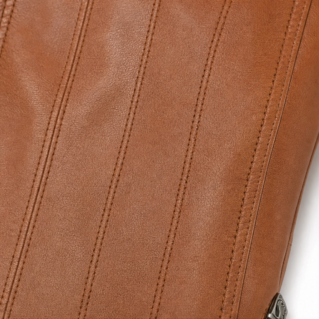 Close-up of brown faux-leather jacket panel with vertical topstitching seams